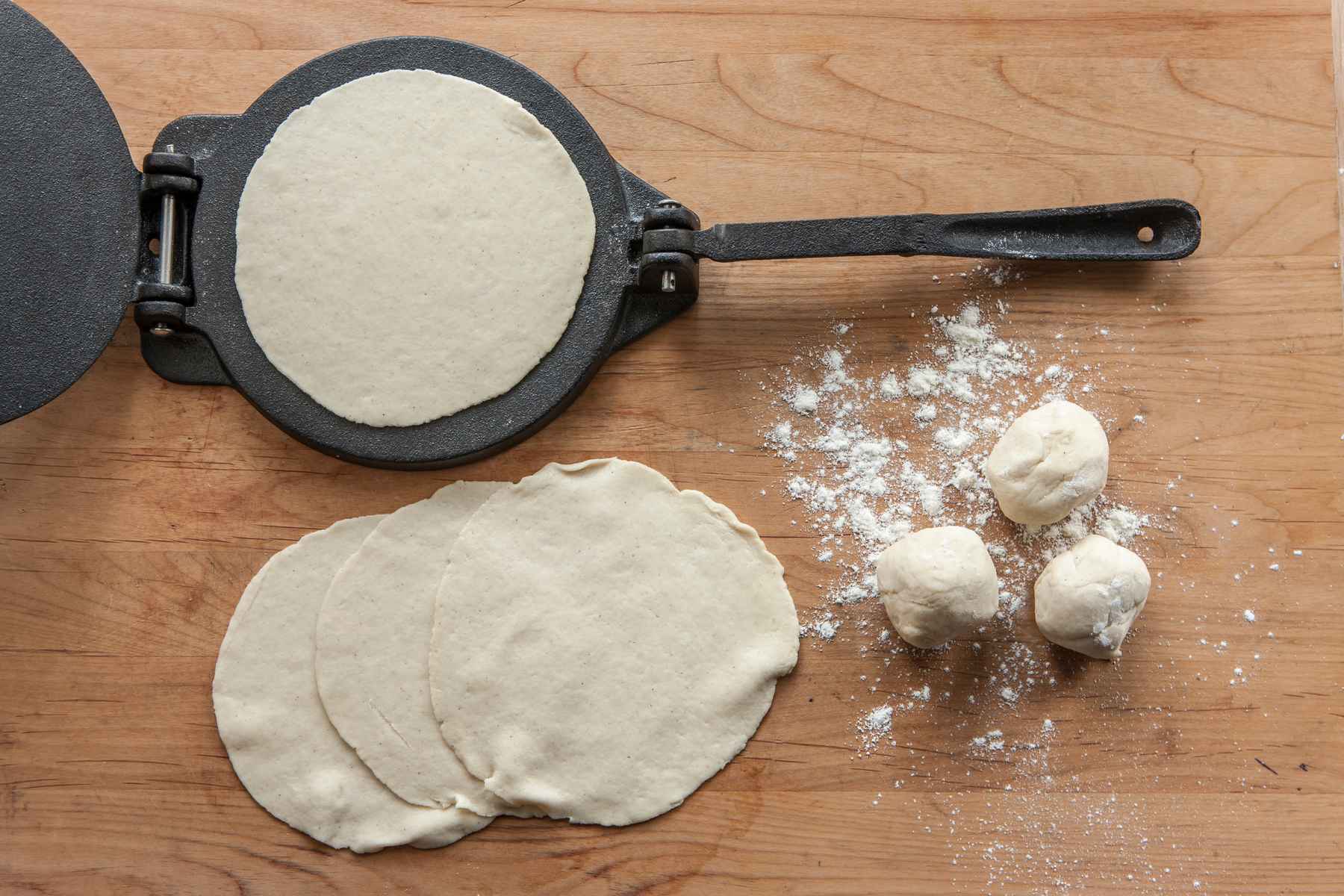 Tortilla maker forming flour tortillas from scratch. Favorite kitchen tools.