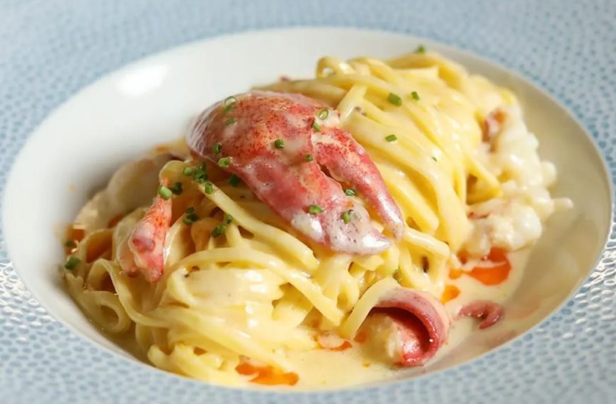 A blue and white dish filled with lobster pasta from Denver's Restaurant Olivia