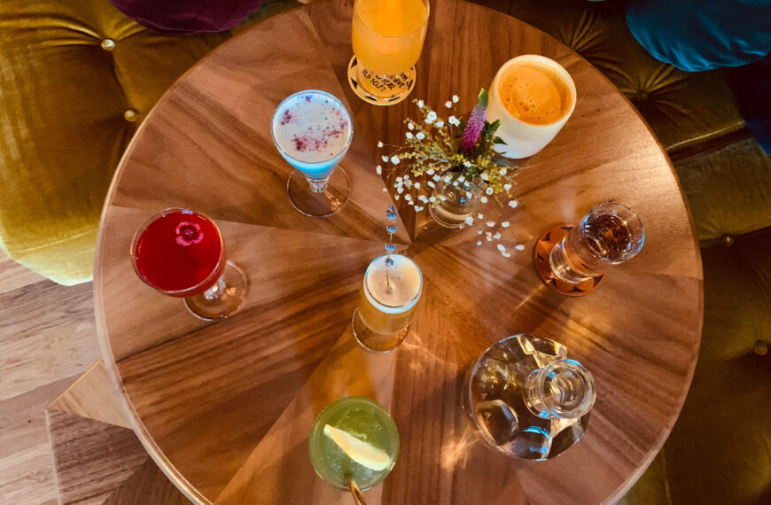 round wood table laden with cocktails