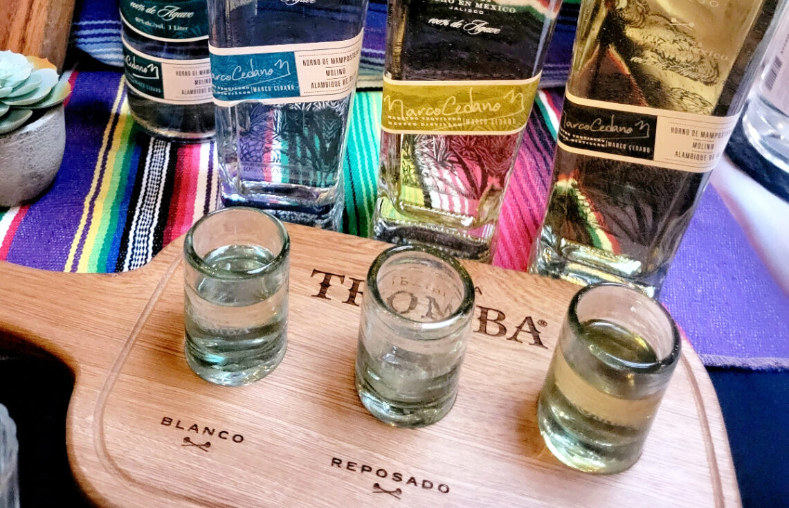 wood board with tequila tasters and bottles