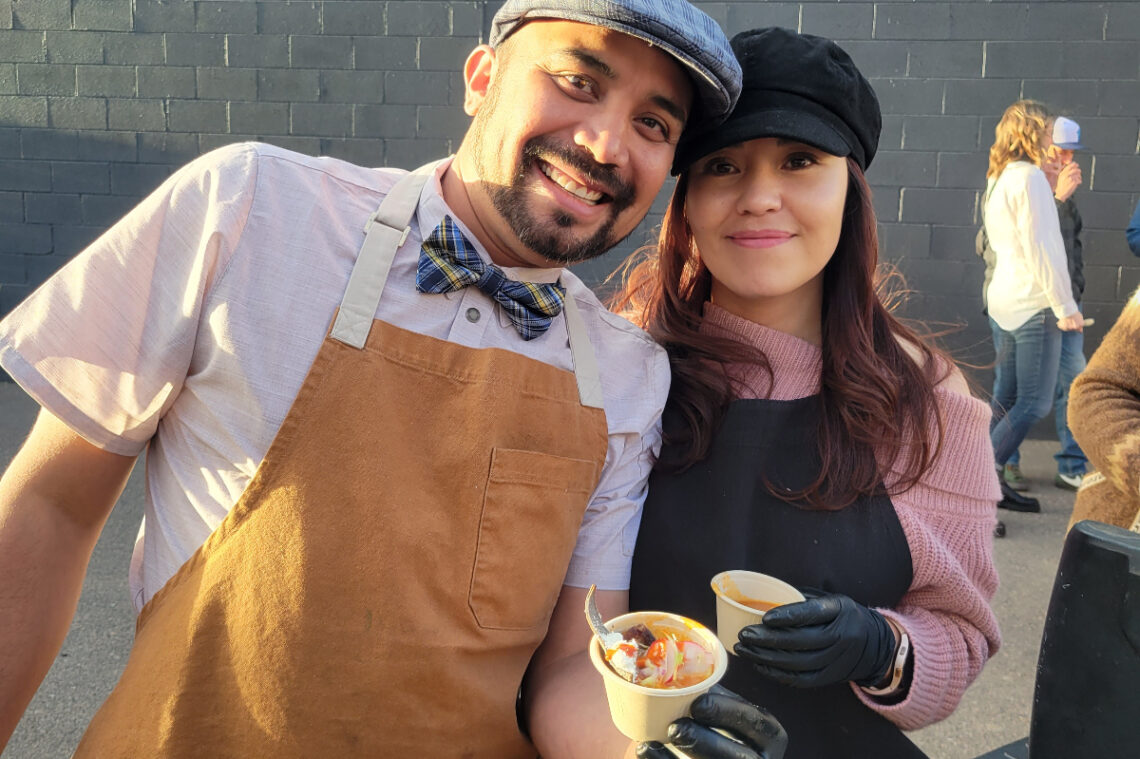 Oscar Padilla with his wife holding pozole at bowl of zole in denver
