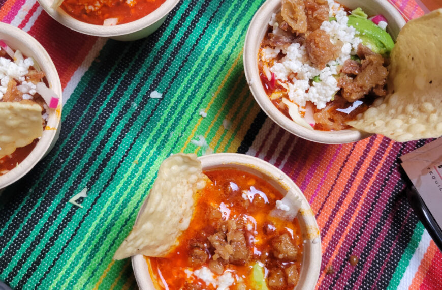 colorful table cloth with small bowls of pozole and chips