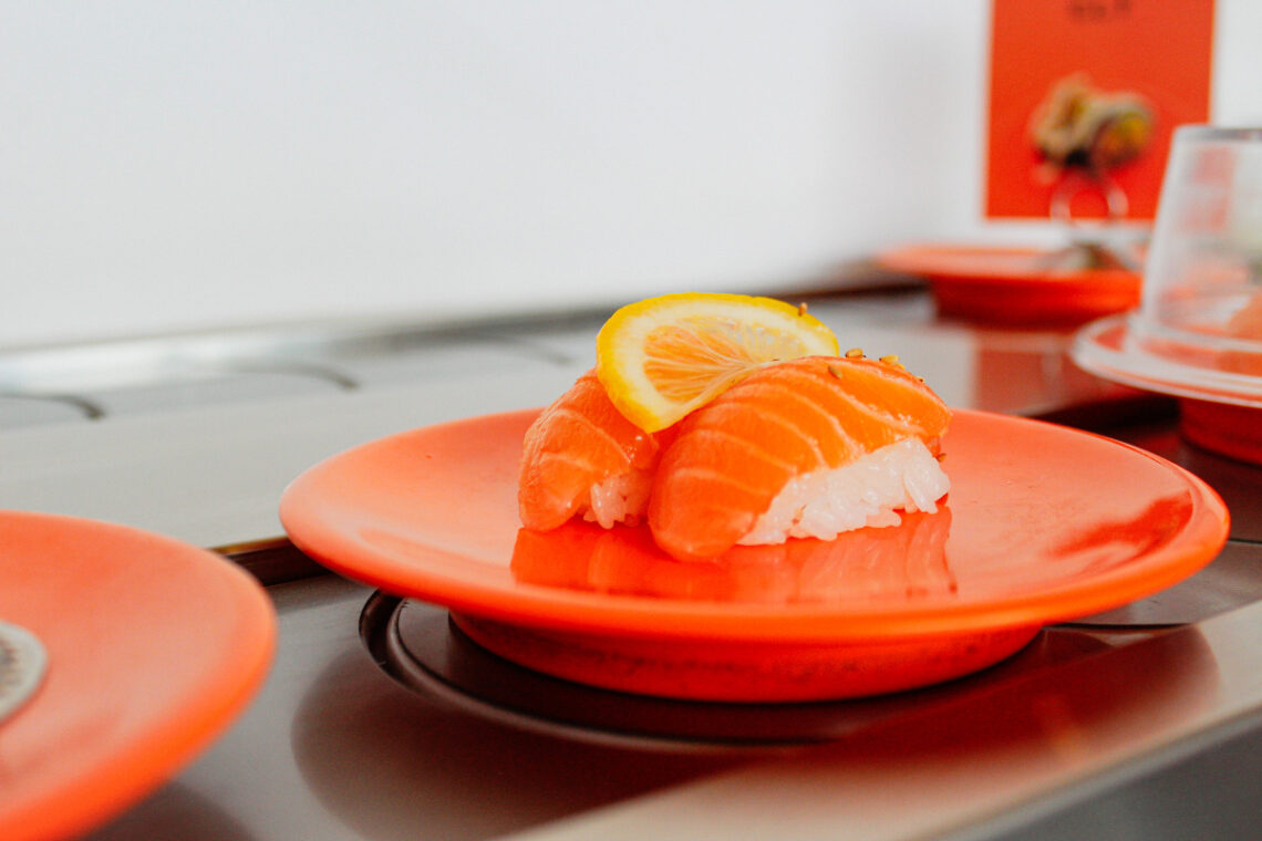 salmon on an orange plate with lemon