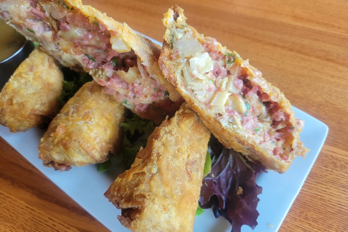 egg rolls stuffed with meat on a white plate