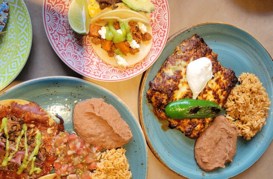 three colorful plates on table with mexican food