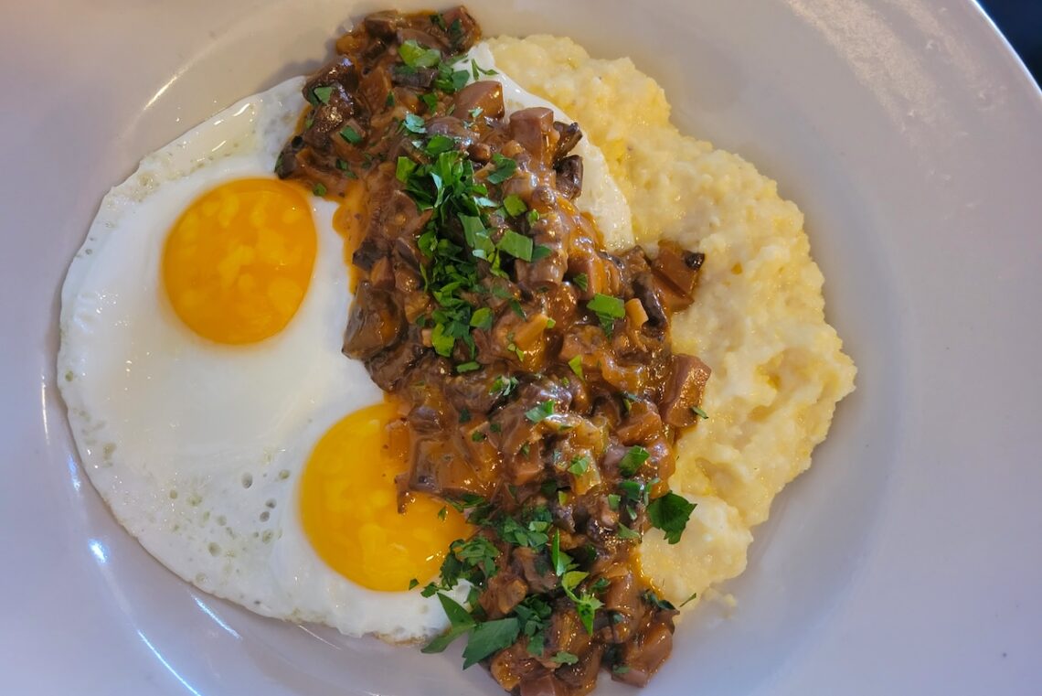 white plate with eggs and polenta