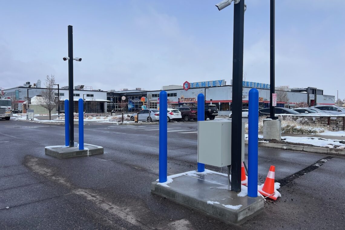 parking lot with blue poles and parking gate