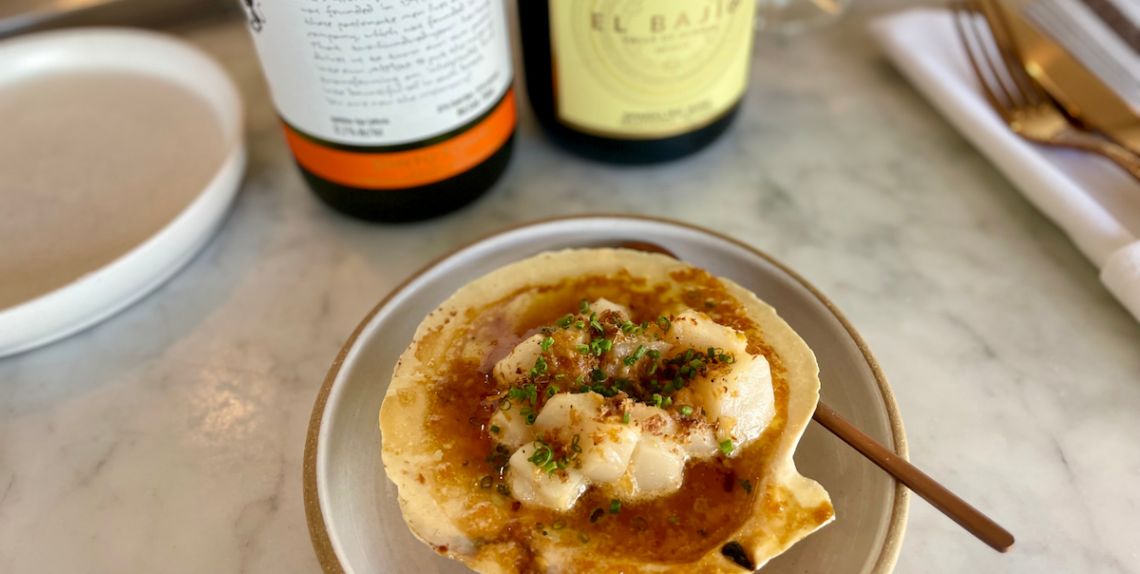 shell with scallops on it and wine bottles