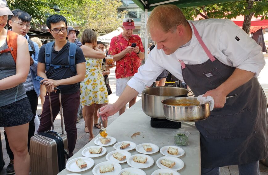 white chef plating food outside