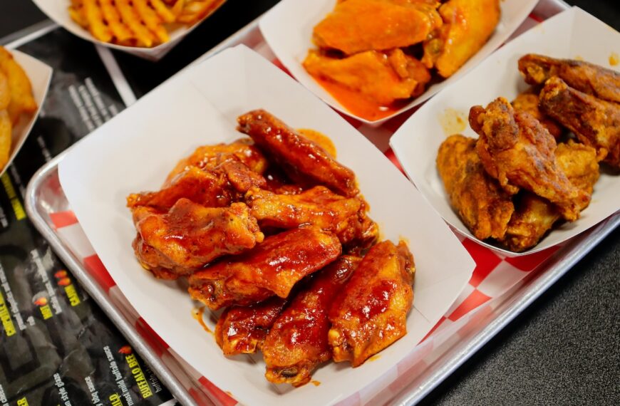 paper bowls with chicken wings and sauce
