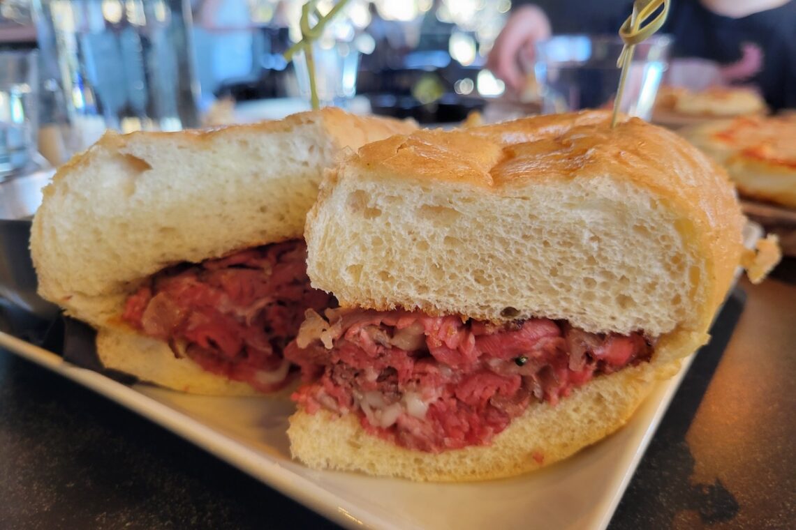 rare beef sandwich on white plate