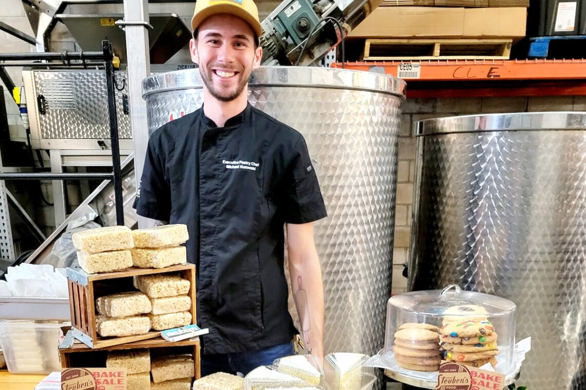 white man standing behind desserts in winery