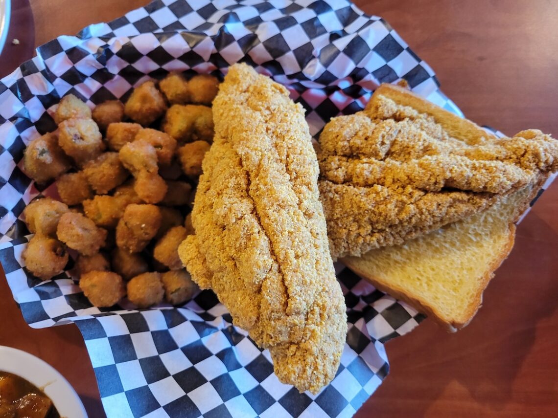 checkered paper with fried catfish and fried okra