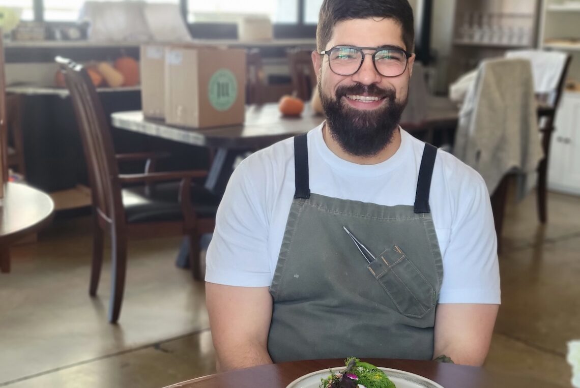 chef in apron sitting and smiling