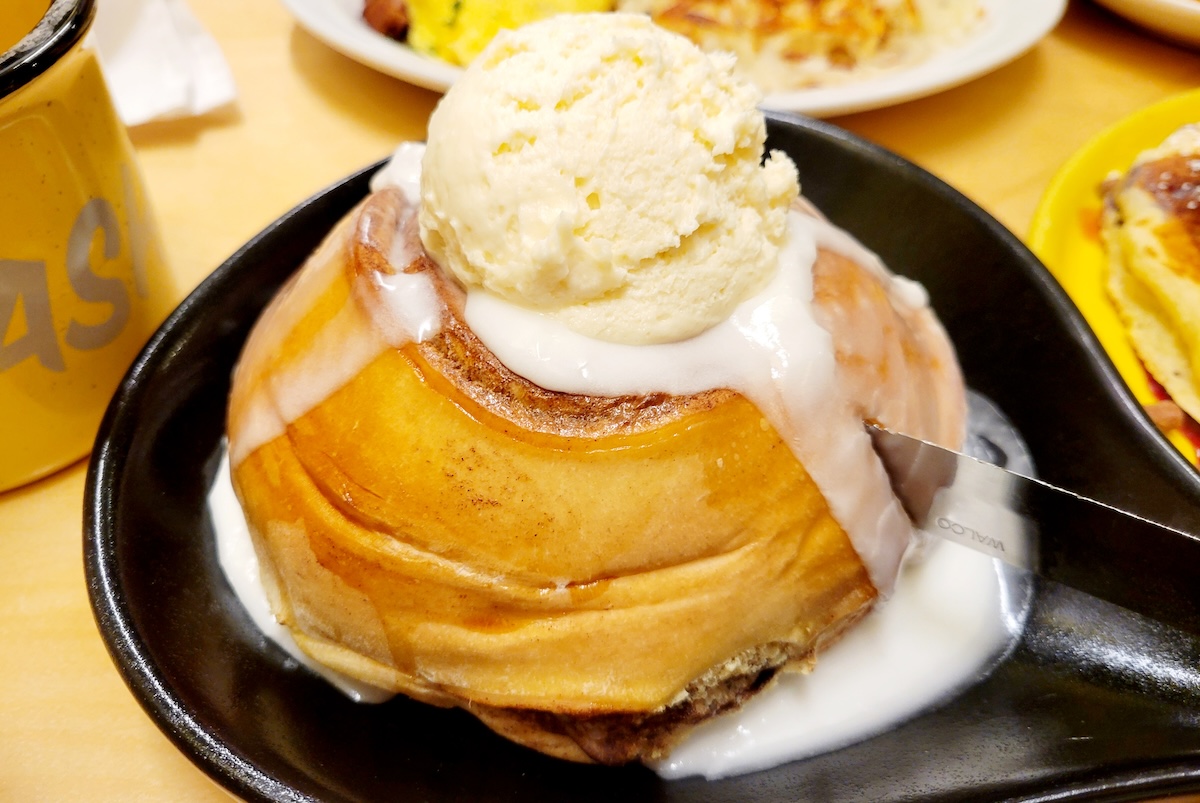 cinnamon roll with icing on skillet