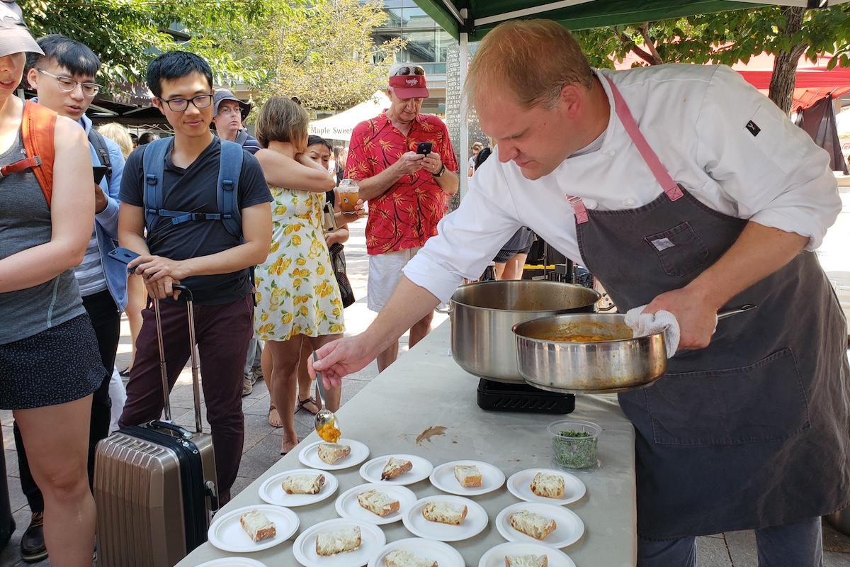 white chef plating food outside