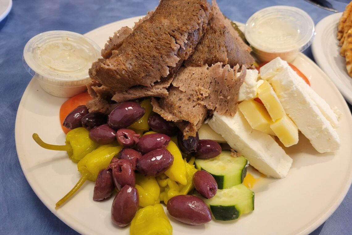 greek platter with gyro and olives and feta