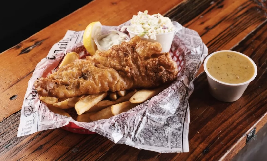 basket of fish and chips on wood table