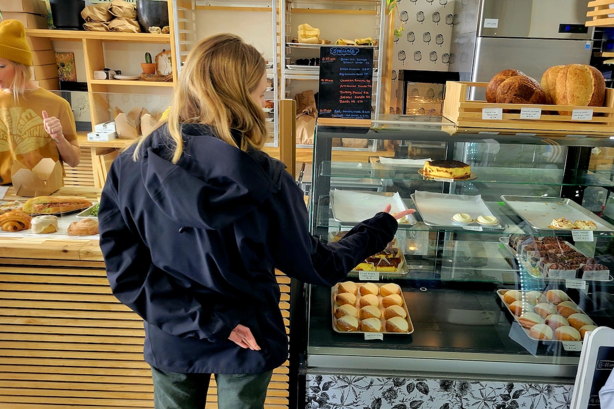 white woman in black sweater at bakery counter