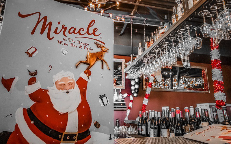 A sign announcing Miracle at The Rouge Wine Bar & Patio, one of the holiday bars popping up in Denver in 2022. 