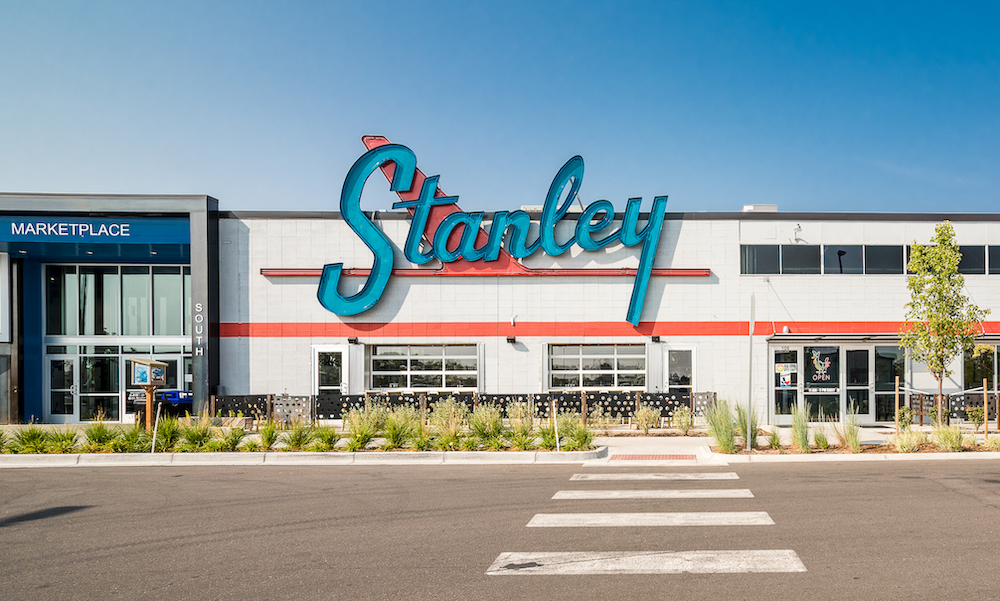 blue sky with building saying stanley in front