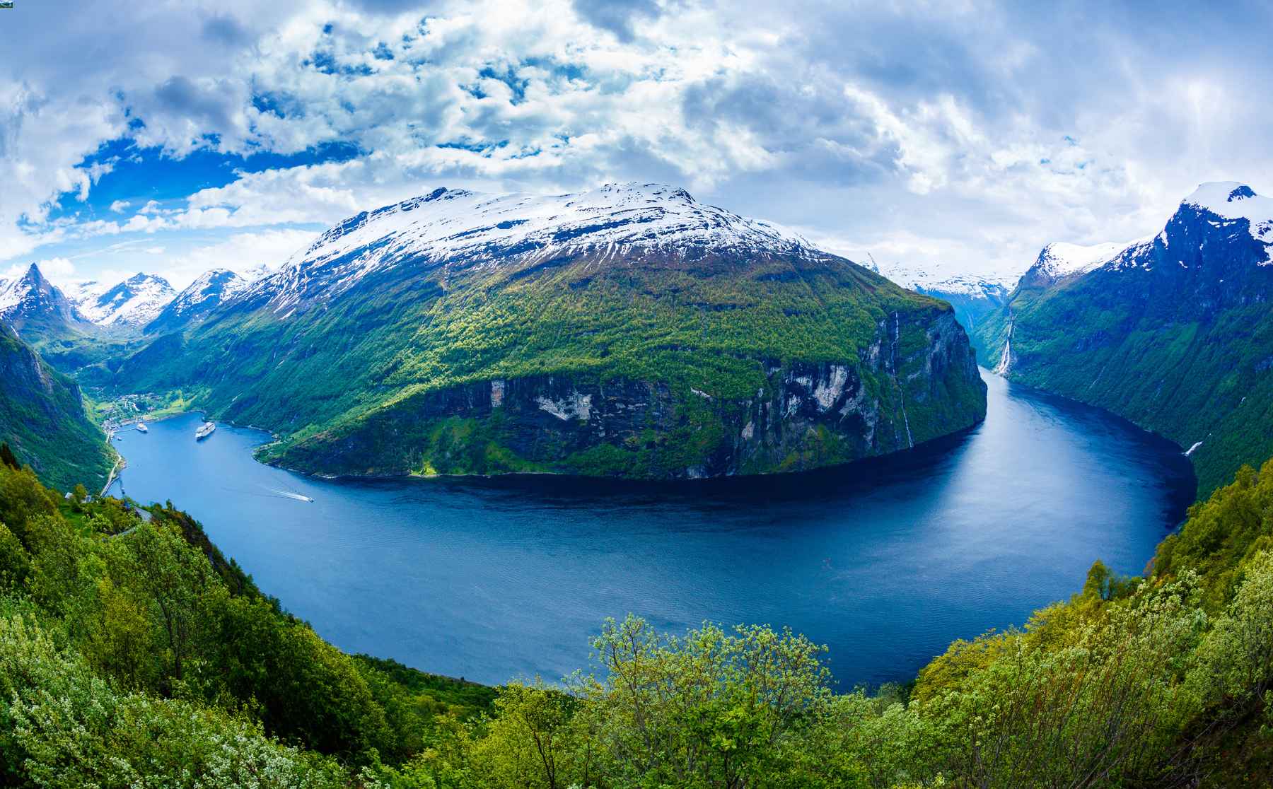 Scandinavian fjord with lush green valley and bright blue water. Inspiration for Stronger mixers.