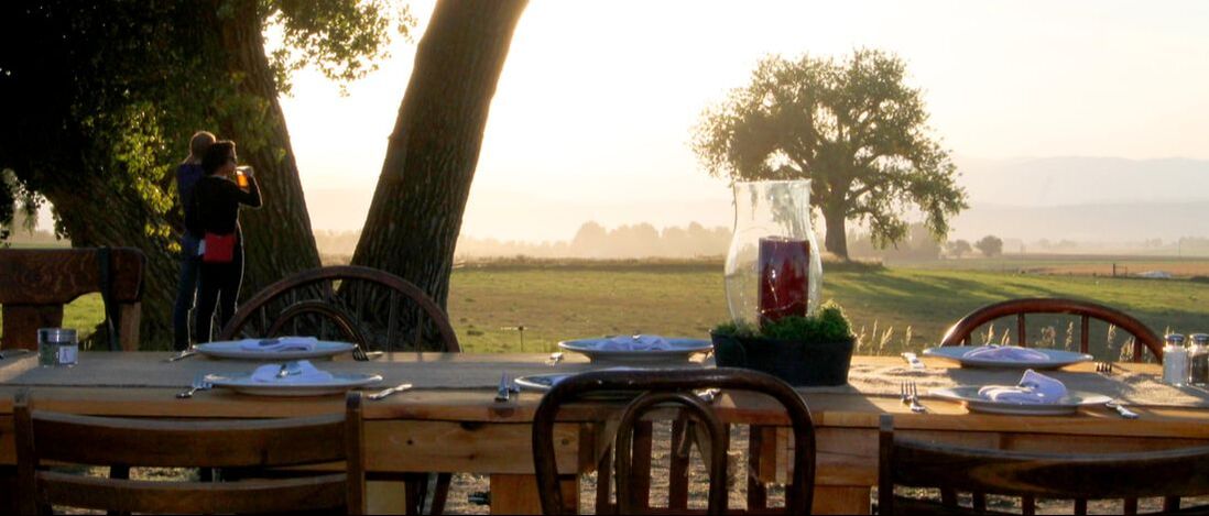 A picture-perfect scene: An 18-acre farm against the backdrop of the Rocky Mountains, a dinner table groaning under the weight of farm-fresh produce, artisan bread, and local craft beverages. A four-course, family-style meal with live music in the air and a motley crew of animals roaming around. The Farmer & Adele farm dinners aren’t just dinners—they’re celebrations of food, music, views, and great company. The menu changes with the seasons, always fresh, always local, with produce sourced from Farmer and Adele and other local farmers. 
