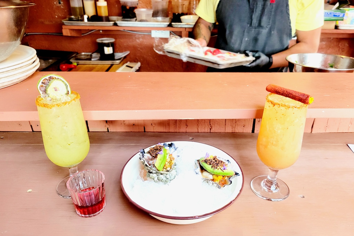 Stuffed oysters with tropical, mezcal-base cocktails. | Photo by Linnea Covington