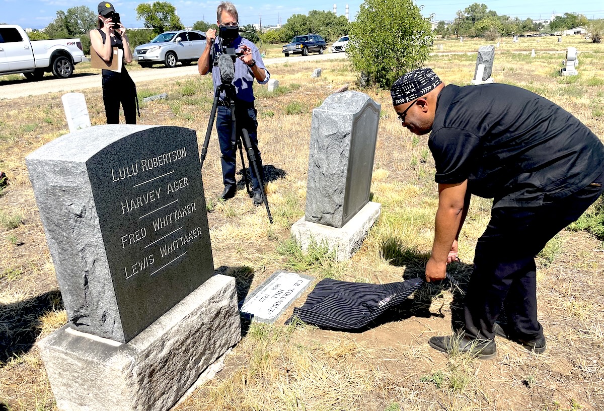 Adrian Miller unveiling the gravestone he bought for C.B. Hill. | Photo by Rebecca Treon