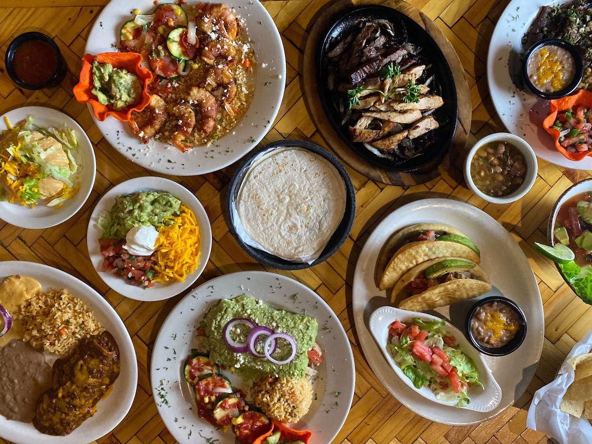 A tablescape at Desperados Mexican Restaurant filled with tacos, fajitas, fresh tortillas, and more. | Photo by Desperados Mexican Restaurant