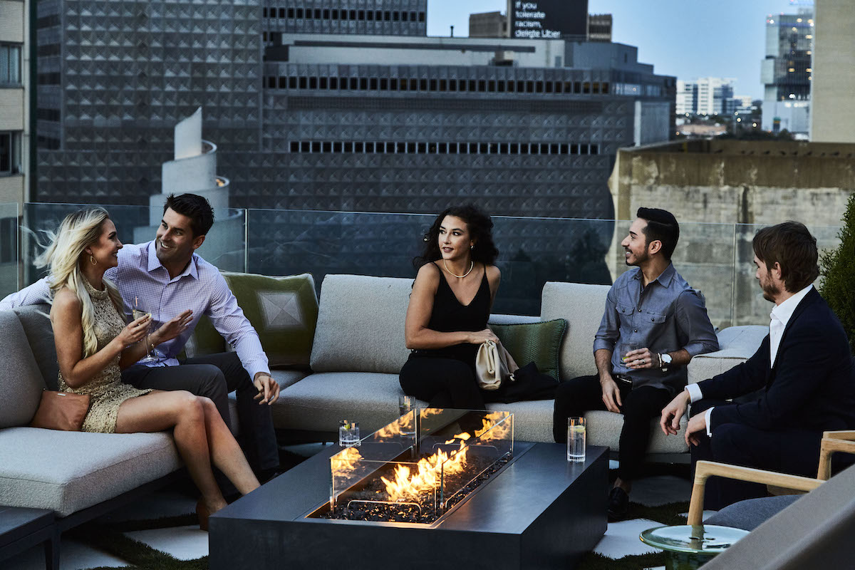 Guests gather around a firepit on the outdoor patio at Catbird. | Photo by Gus Schmiege 