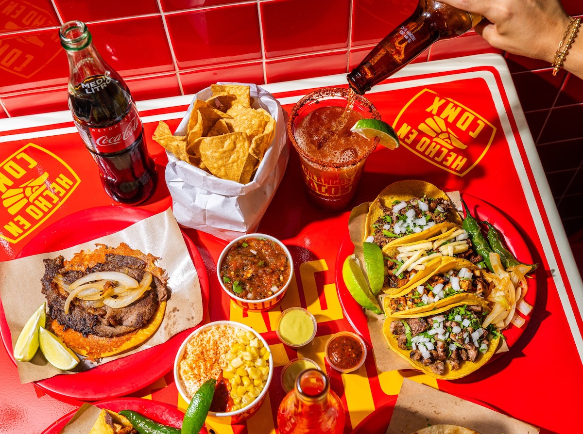 A spread of tacos, chips, elote and more at Chilangos Tacos. | Photo by Chilangos Tacos