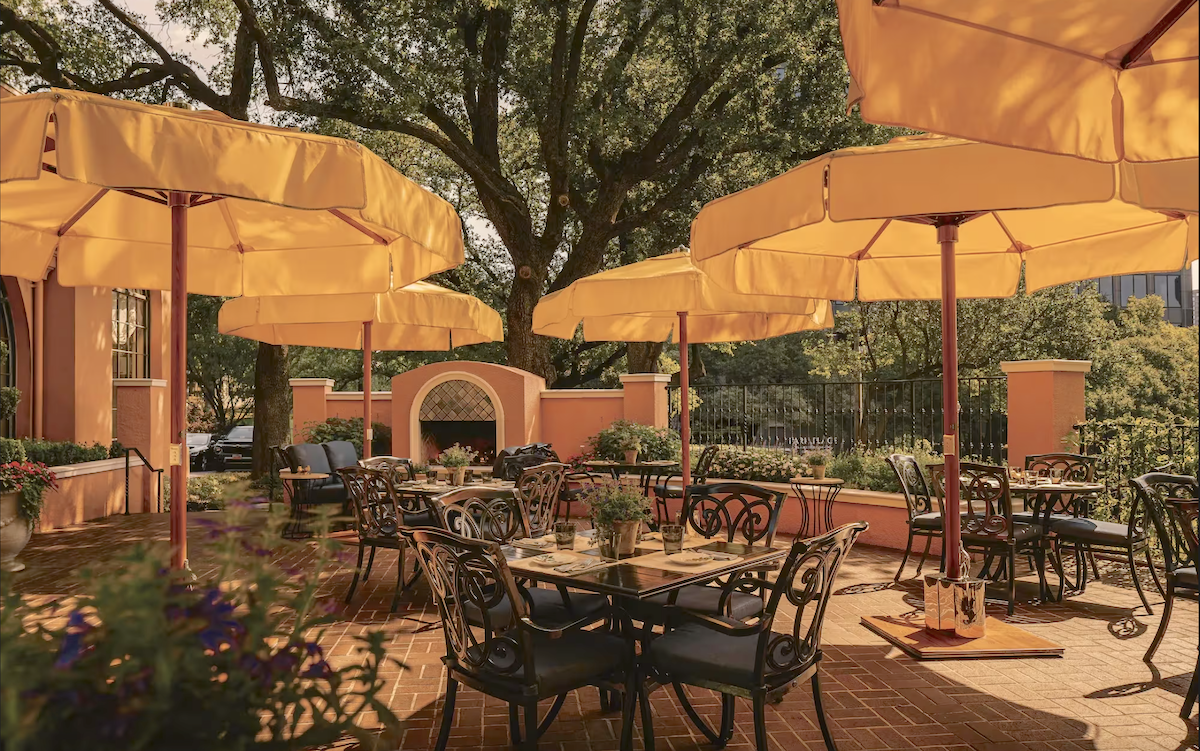 Mansion - DiningOut Bright yellow umbrellas dot the space at the Mansion Restaurant Terrace. | Photo by Rosewood Hotels