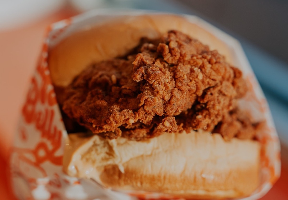 Stuffed Belly’s Sichuan hot chicken sandwich delivers a fiery kick, pairing buttermilk-fried chicken with numbing Sichuan spices, creamy mayo, and pickles on a potato bun. | Photo by Stuffed Belly