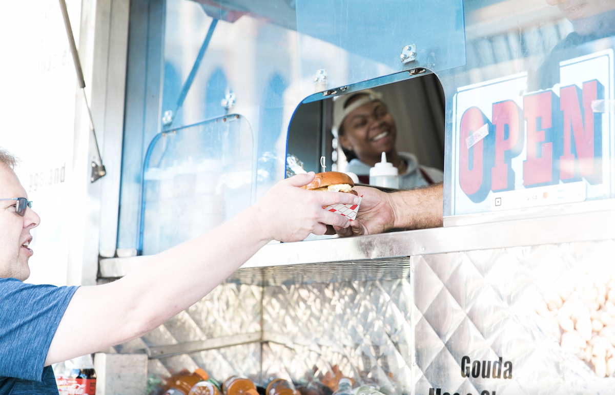 Egg Stand - DiningOut A customer receives his order at the Egg Stand food truck. | Photo by Egg Stand