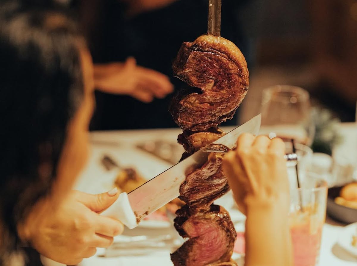 Servers carve fire-roasted cuts tableside at Fogo de Chão. | Photo by Fogo de Chão