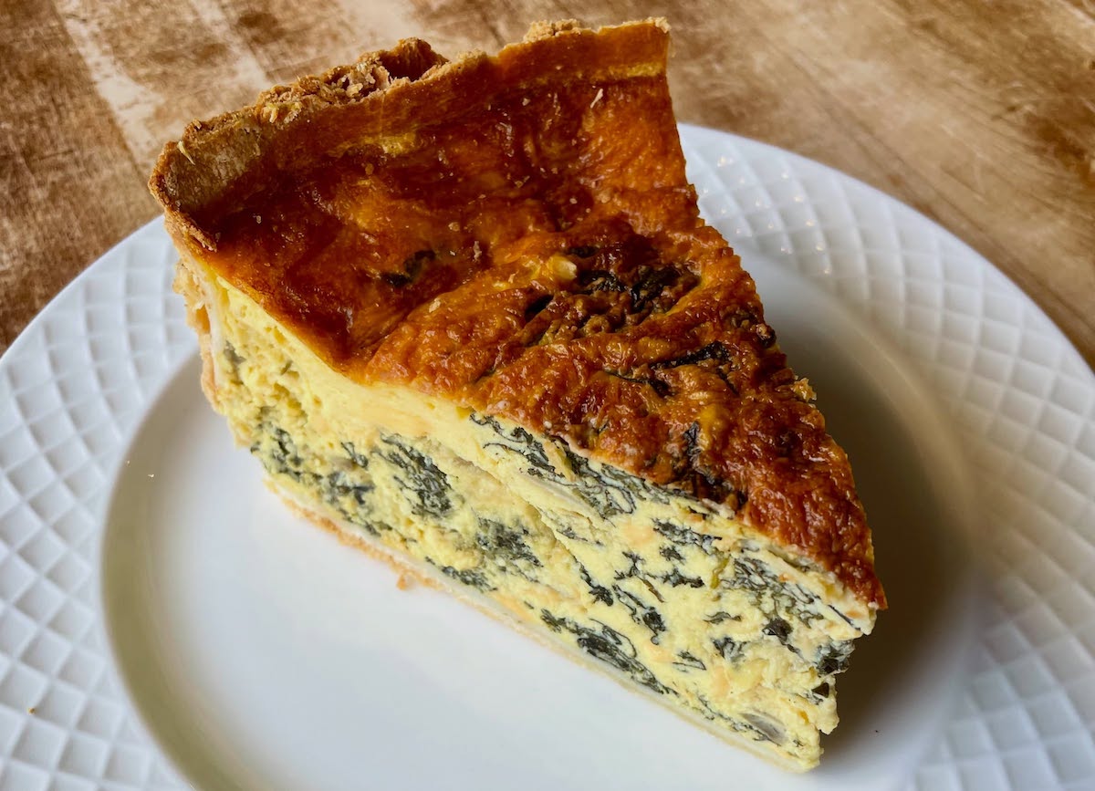 A slice of vegan spinach and artichoke quiche at Sinfull Bakery. | Photo by Sinfull Bakery