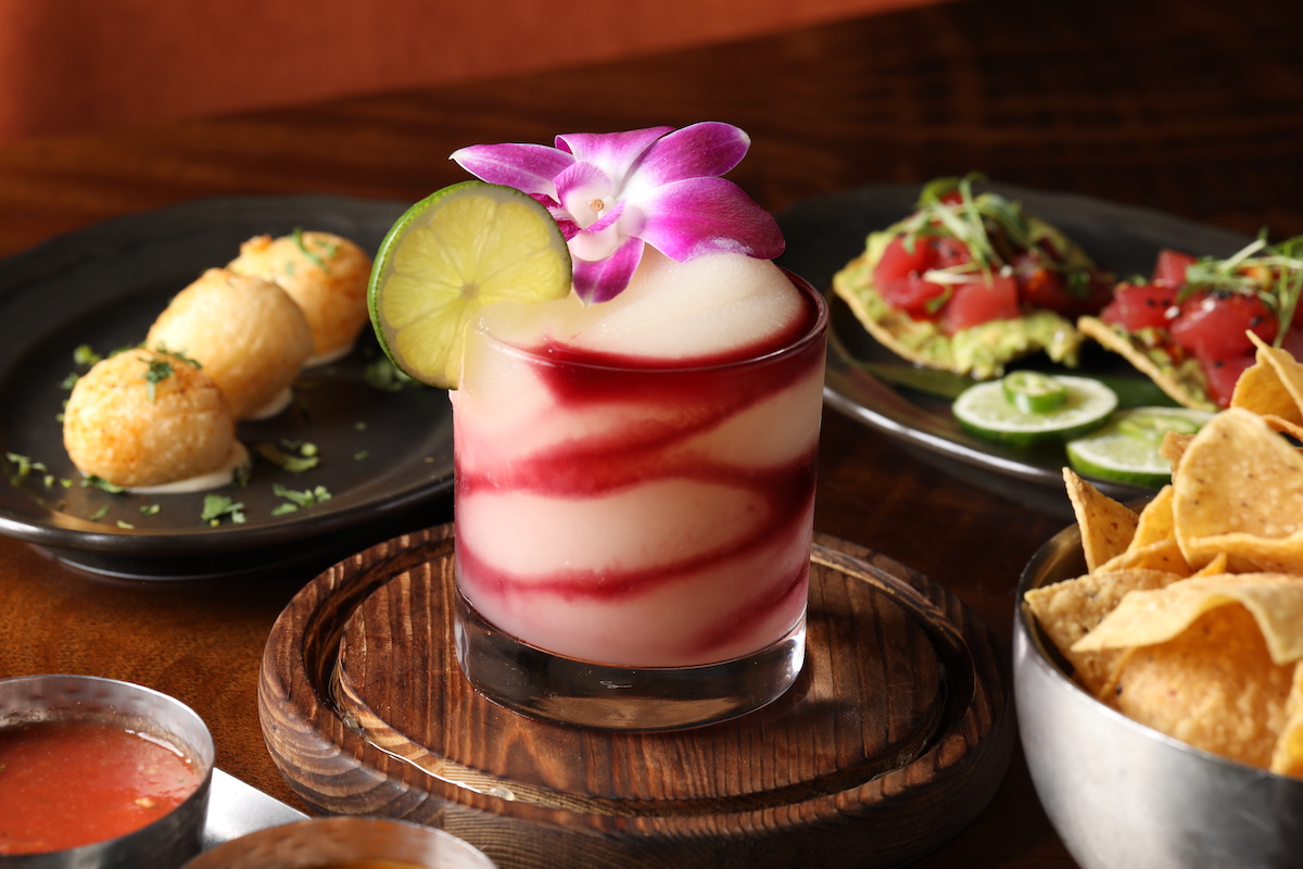 A frozen margarita anchors a table of happy hour snacks at Miriam Cocina Latina. | Photo by Raynor Brumfield