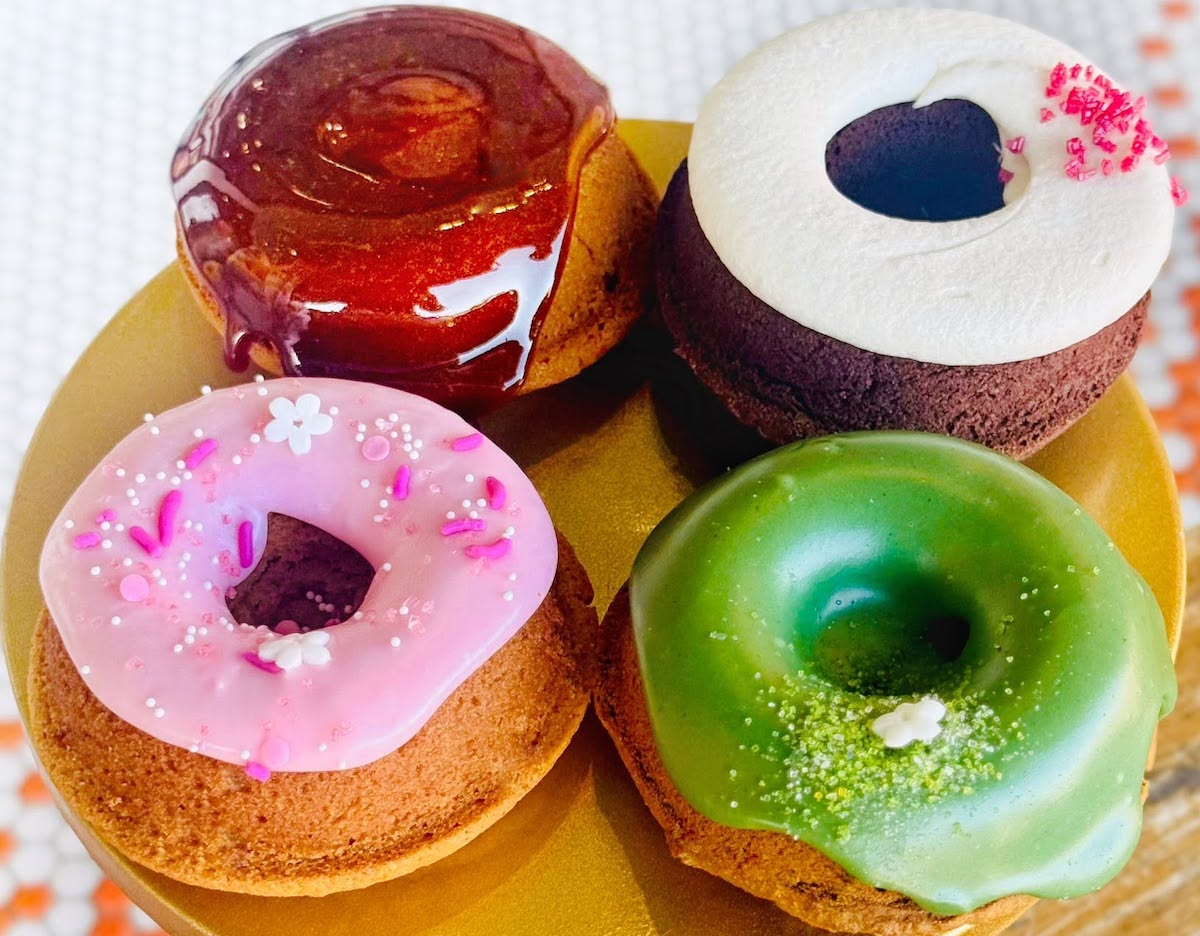 A colorful assortment of glazed and frosted doughnuts at Awesome Bites. | Photo by Awesome Bites