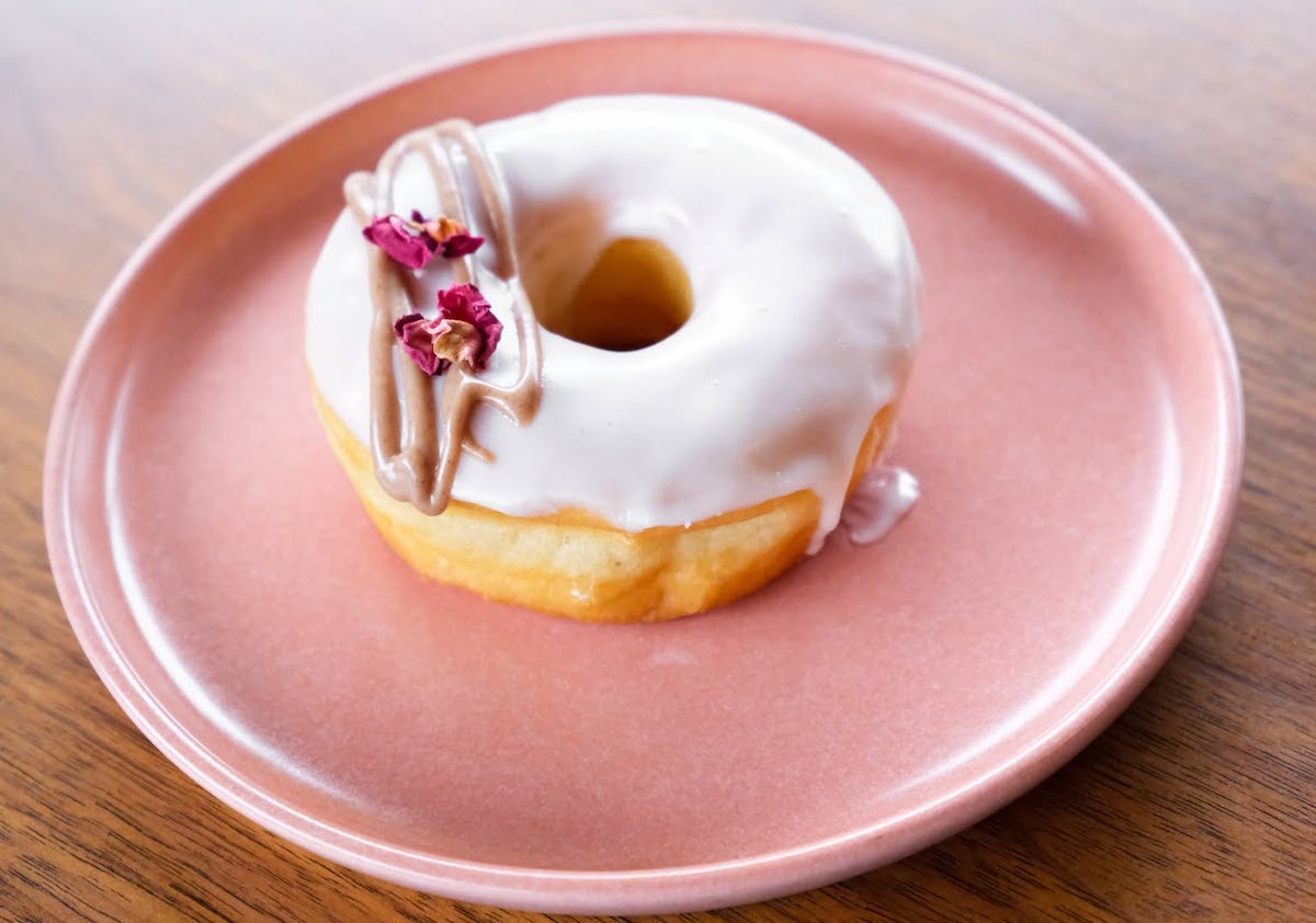An iced doughnut with a delicate drizzle at Coco's Donuts & Coffee Bar. | Photo by Coco's Donuts & Coffee Bar