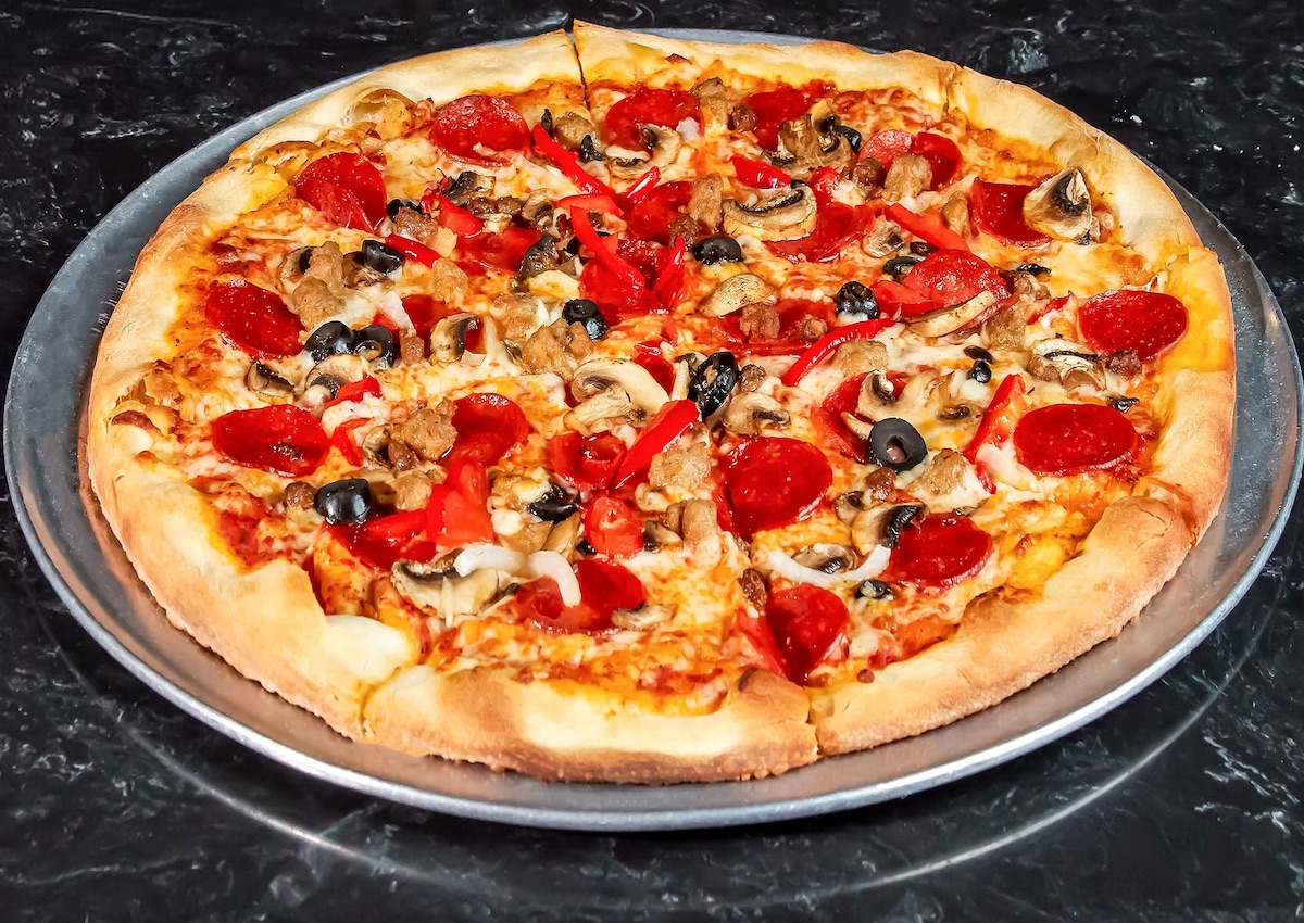 Pizza with pepperoni, olives, and peppers at Eddie's Napolis. | Photo by Eddie's Napolis