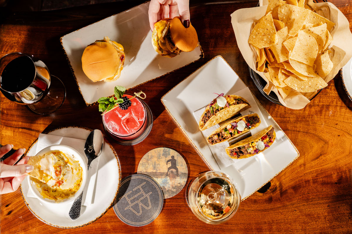 A hearty happy hour spread with food and cocktails at Haywire. | Photo by Kayla Enright