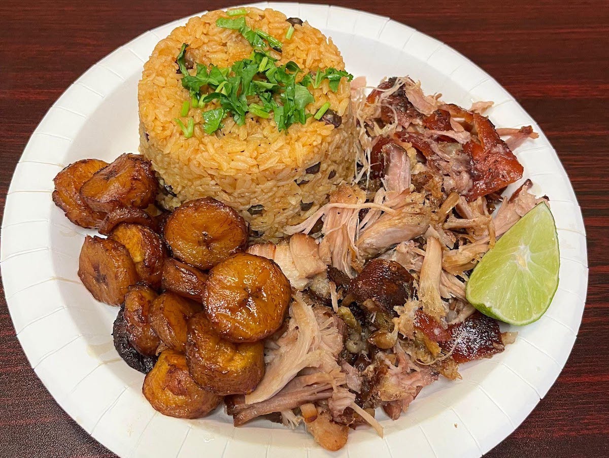 Rice with pigeon peas, roasted pork, and sweet plantains at Sazon Tropicale. | Photo by Sazon Tropicale