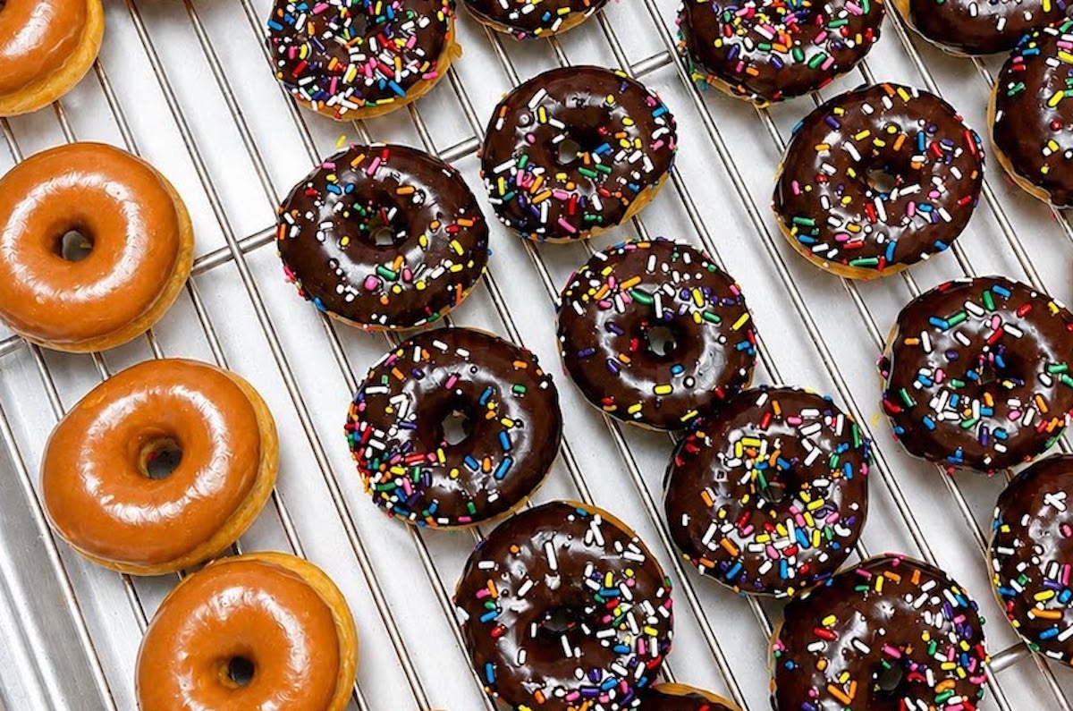 Rows of hot and fresh classic glazed and chocolate-sprinkle doughnuts at Southern Comfort. | Photo by Southern Comfort