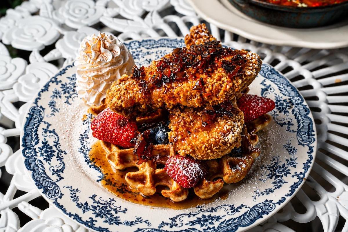 The Bloom Lounge - DiningOut Fried chicken and waffles on decorative plates at the Bloom Lounge. | Photo by the Bloom Lounge