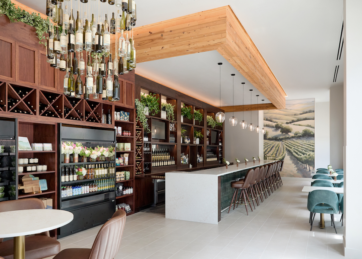 A wine bottle chandelier is suspended from the ceiling at the Board Room at CITYCENTRE. | Photo by Natalie Goff