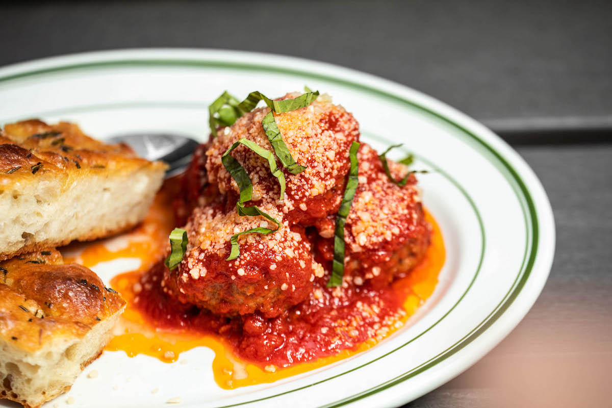 ilBracco_meatballs - DiningOut House-made meatballs are served with rich tomato sauce, shaved Parmesan, fresh basil, and warm focaccia at Il Bracco. | Photo by Il Bracco