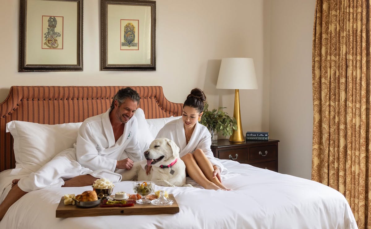 Hotel Granduca HTX - DiningOut A couple enjoys a cozy hotel stay with their pup at Hotel Granduca, where four-legged guests can join in on the luxury. | Photo by Hotel Granduca Houston