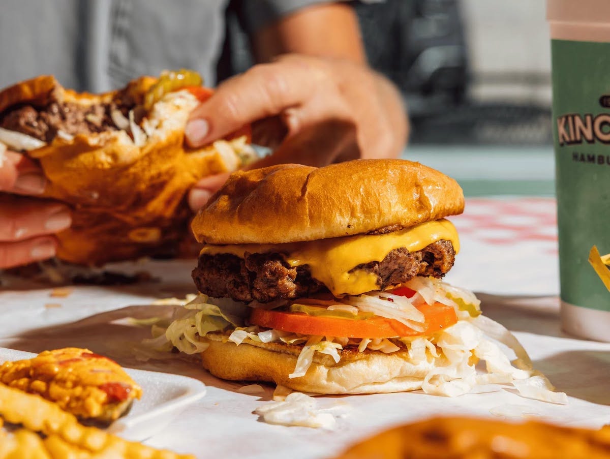 Kincaids - DiningOut A classic double cheeseburger from Kincaid's Hamburgers, piled with crisp lettuce, tomatoes, onions, and pickles on a toasted bun. | Photo by Kincaid's Hamburgers