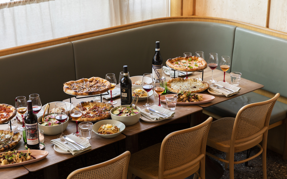 A giant spread of pasta, wine, and pizza at Rosie Cannonball. | Photo by Zach Horst